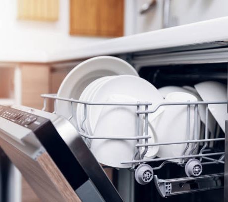 open dishwasher with clean dishes at home kitchen